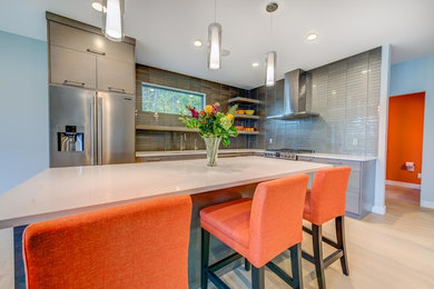 Example of a small trendy l-shaped light wood floor eat-in kitchen design in Other with an undermount sink, flat-panel cabinets, gray cabinets, quartz countertops, gray backsplash, glass tile backsplash, stainless steel appliances and an island