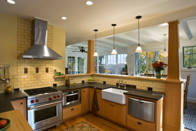 Example of a classic kitchen design in Other with subway tile backsplash, a farmhouse sink, concrete countertops, shaker cabinets, medium tone wood cabinets and stainless steel appliances