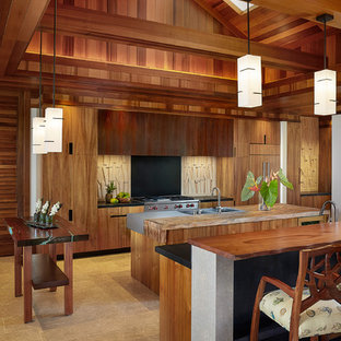 Photo of a large tropical open plan kitchen in Hawaii with a double-bowl sink, flat-panel cabinets, medium wood cabinets, wood benchtops and multiple islands.
