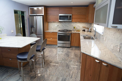 Example of a mid-sized trendy l-shaped enclosed kitchen design in New York with a drop-in sink, flat-panel cabinets, medium tone wood cabinets, granite countertops, blue backsplash, stone slab backsplash, stainless steel appliances and an island