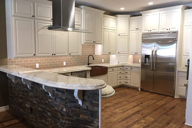 Minimalist l-shaped medium tone wood floor eat-in kitchen photo in Dallas with an undermount sink, raised-panel cabinets, white cabinets, granite countertops, subway tile backsplash, stainless steel appliances and an island