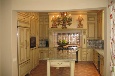 Eat-in kitchen - mid-sized 1960s u-shaped terra-cotta tile eat-in kitchen idea in San Francisco with an undermount sink, recessed-panel cabinets, yellow cabinets, granite countertops, multicolored backsplash, ceramic backsplash, stainless steel appliances and an island