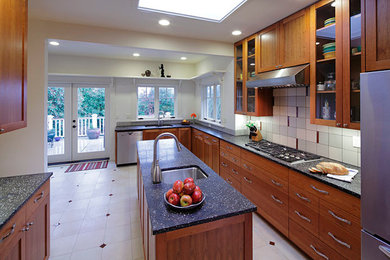 Eat-in kitchen - large transitional eat-in kitchen idea in Seattle with a drop-in sink, flat-panel cabinets, medium tone wood cabinets, multicolored backsplash, stainless steel appliances, an island and ceramic backsplash
