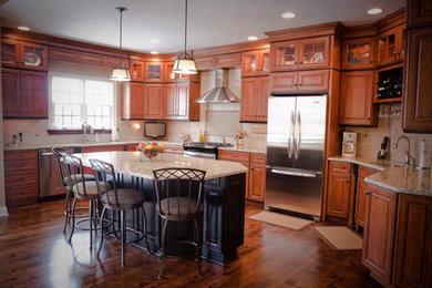 Eat-in kitchen - traditional u-shaped eat-in kitchen idea in Other with stainless steel appliances and an island