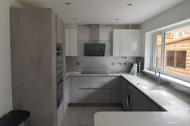 Contemporary kitchen in Other with grey worktops.