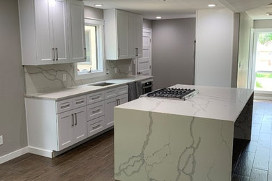 Example of a large transitional u-shaped porcelain tile and brown floor eat-in kitchen design in Miami with an undermount sink, recessed-panel cabinets, dark wood cabinets, quartzite countertops, white backsplash, stone slab backsplash, stainless steel appliances, an island and white countertops