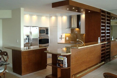 Eat-in kitchen - mid-sized modern eat-in kitchen idea in Miami with flat-panel cabinets, white cabinets, granite countertops and stainless steel appliances