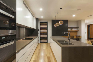 Design ideas for a large contemporary kitchen in London with black appliances.