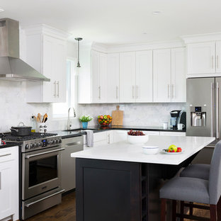 Large transitional eat-in kitchen ideas - Inspiration for a large transitional l-shaped medium tone wood floor eat-in kitchen remodel in DC Metro with white cabinets, gray backsplash, marble backsplash, stainless steel appliances, an island and shaker cabinets