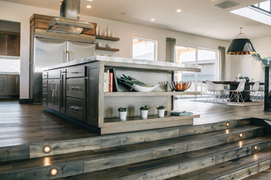 Example of a large trendy l-shaped dark wood floor eat-in kitchen design in Denver with shaker cabinets, dark wood cabinets, marble countertops, stainless steel appliances and an island