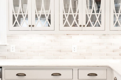 Inspiration for a large classic u-shaped kitchen in Indianapolis with raised-panel cabinets and white cabinets.