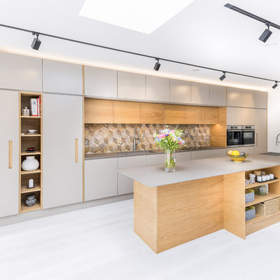 Kitchen - large contemporary single-wall gray floor kitchen idea in London with flat-panel cabinets, gray cabinets, multicolored backsplash, stainless steel appliances, an island, gray countertops and ceramic backsplash