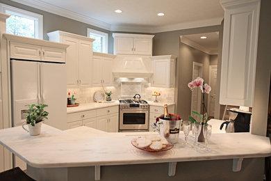 Kitchen - mid-sized traditional kitchen idea in Other with white cabinets, marble countertops and marble backsplash