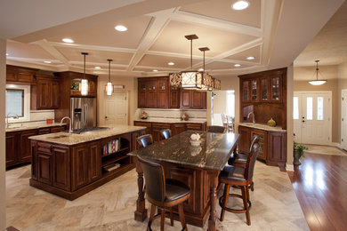 Inspiration for a large timeless ceramic tile and beige floor eat-in kitchen remodel in St Louis with an undermount sink, recessed-panel cabinets, medium tone wood cabinets, granite countertops, stainless steel appliances, beige backsplash, porcelain backsplash and two islands