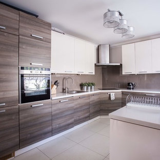 This is an example of a mid-sized modern single-wall eat-in kitchen in Las Vegas with flat-panel cabinets, white cabinets, laminate benchtops, white splashback, plywood floors, with island, beige floor and white benchtop.