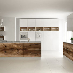Photo of a mid-sized modern single-wall eat-in kitchen in Las Vegas with flat-panel cabinets, white cabinets, laminate benchtops, white splashback, plywood floors, with island, beige floor and white benchtop.
