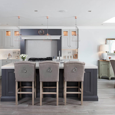 Inspiration for a large timeless l-shaped porcelain tile and brown floor open concept kitchen remodel in Other with an undermount sink, shaker cabinets, gray cabinets, quartzite countertops, gray backsplash, stone slab backsplash, stainless steel appliances and an island