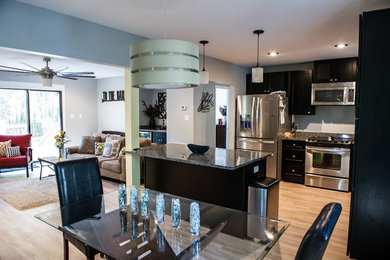 Minimalist light wood floor eat-in kitchen photo in Atlanta with granite countertops, stainless steel appliances and an island