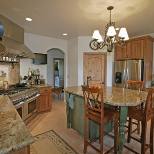 Inspiration for a country kitchen in San Luis Obispo with glass-front cabinets, stainless steel appliances, light wood cabinets, multi-coloured splashback, stone tile splashback and granite benchtops.