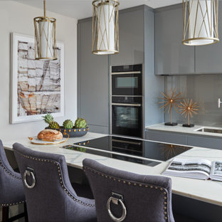 Inspiration for a small contemporary kitchen in Other with a double-bowl sink, flat-panel cabinets, grey cabinets, grey splashback, integrated appliances, an island and white worktops.