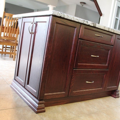 Eat-in kitchen - mid-sized transitional l-shaped travertine floor eat-in kitchen idea in Toronto with recessed-panel cabinets, medium tone wood cabinets, granite countertops, gray backsplash, matchstick tile backsplash, stainless steel appliances and an island