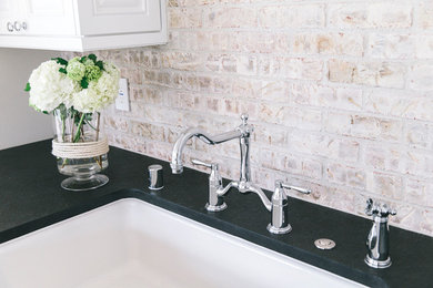 Inspiration for a kitchen remodel in Orange County with a farmhouse sink, beaded inset cabinets, white cabinets, granite countertops, multicolored backsplash and subway tile backsplash