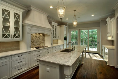 Example of a painted wood floor kitchen design in Richmond with flat-panel cabinets, yellow cabinets, granite countertops, white backsplash, cement tile backsplash, stainless steel appliances and an island
