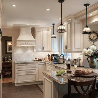 This is an example of a mid-sized traditional u-shaped eat-in kitchen in Montreal with a double-bowl sink, beaded inset cabinets, white cabinets, granite benchtops, beige splashback, stone tile splashback, panelled appliances, slate floors, a peninsula and grey floor.