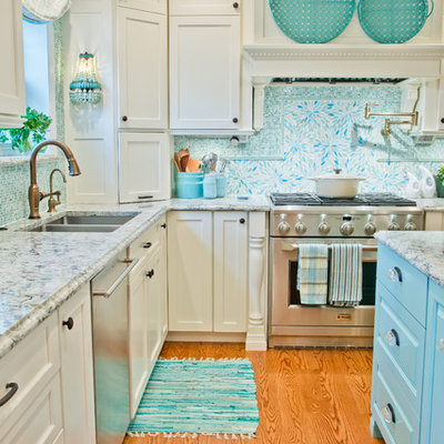 Example of a transitional medium tone wood floor kitchen design in St Louis with white cabinets, marble countertops, blue backsplash, stainless steel appliances, an island, an undermount sink, shaker cabinets and mosaic tile backsplash