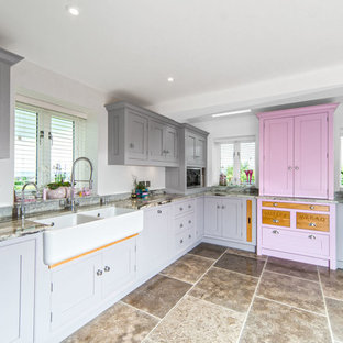 This is an example of a medium sized classic l-shaped kitchen in Other with a belfast sink, recessed-panel cabinets, marble worktops, stainless steel appliances, brown floors and grey worktops.
