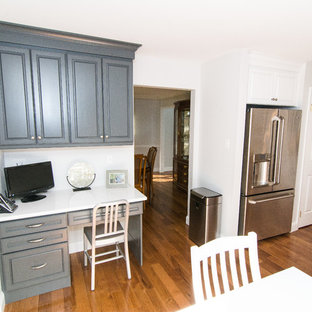 Large traditional kitchen remodeling - Large elegant l-shaped medium tone wood floor and brown floor kitchen photo in Philadelphia with a double-bowl sink, raised-panel cabinets, white cabinets, quartz countertops, gray backsplash, ceramic backsplash and stainless steel appliances
