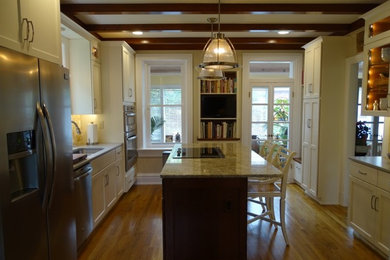 Eat-in kitchen - mid-sized transitional u-shaped medium tone wood floor eat-in kitchen idea in Other with an undermount sink, shaker cabinets, white cabinets, granite countertops, beige backsplash, ceramic backsplash, stainless steel appliances and an island