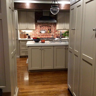 Mid-sized transitional eat-in kitchen photos - Eat-in kitchen - mid-sized transitional galley dark wood floor eat-in kitchen idea in Raleigh with an undermount sink, shaker cabinets, beige cabinets, quartz countertops, red backsplash, brick backsplash, stainless steel appliances and an island