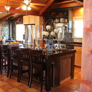 Design ideas for a large country galley eat-in kitchen in Boise with a farmhouse sink, open cabinets, light wood cabinets, wood benchtops, beige splashback, stainless steel appliances, terra-cotta floors, with island, slate splashback and orange floor.