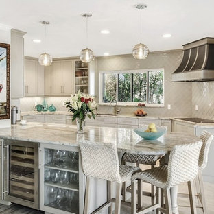 Traditional kitchen ideas - Example of a classic beige floor kitchen design in Other with granite countertops, a peninsula, an undermount sink, recessed-panel cabinets, beige cabinets and beige backsplash