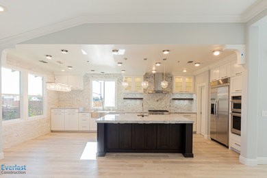 Inspiration for a large modern l-shaped eat-in kitchen remodel in San Francisco with white cabinets and an island