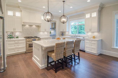Mid-sized elegant u-shaped dark wood floor and brown floor eat-in kitchen photo in Vancouver with an undermount sink, shaker cabinets, white cabinets, marble countertops, white backsplash, mosaic tile backsplash, stainless steel appliances, an island and white countertops