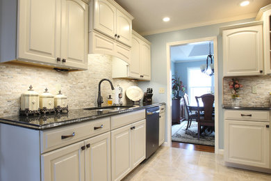 Example of a small classic u-shaped ceramic tile eat-in kitchen design in Nashville with a double-bowl sink, recessed-panel cabinets, beige cabinets, granite countertops, gray backsplash and stone tile backsplash