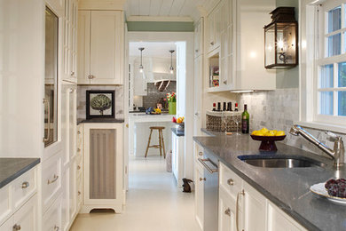 Example of a mid-sized trendy galley enclosed kitchen design in Miami with a single-bowl sink, recessed-panel cabinets, white cabinets, gray backsplash, stainless steel appliances and no island