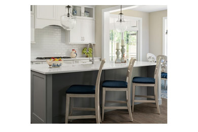 Inspiration for a mid-sized cottage single-wall medium tone wood floor and brown floor eat-in kitchen remodel in Other with a farmhouse sink, shaker cabinets, white cabinets, white backsplash, subway tile backsplash, an island and white countertops