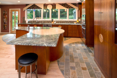 Example of a large trendy l-shaped slate floor eat-in kitchen design in Columbus with a double-bowl sink, flat-panel cabinets, medium tone wood cabinets, marble countertops, multicolored backsplash, mosaic tile backsplash, stainless steel appliances and an island