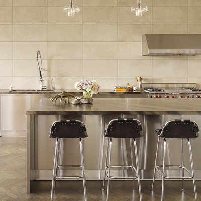 Kitchen - contemporary kitchen idea in San Francisco with stainless steel appliances and travertine backsplash