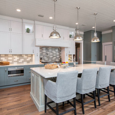 Example of a large transitional u-shaped kitchen design in Jacksonville with shaker cabinets, multicolored backsplash, subway tile backsplash, stainless steel appliances and an island