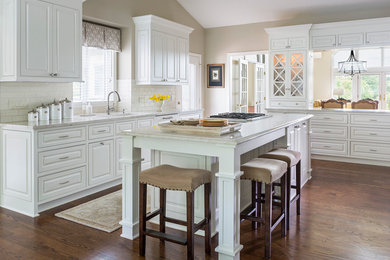 Eat-in kitchen - large transitional u-shaped dark wood floor eat-in kitchen idea in Minneapolis with an undermount sink, raised-panel cabinets, white cabinets, granite countertops, white backsplash, subway tile backsplash and an island