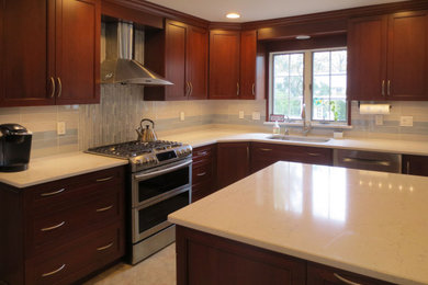 Example of a small transitional l-shaped travertine floor, beige floor and wood ceiling kitchen design in New York with an undermount sink, shaker cabinets, medium tone wood cabinets, quartz countertops, gray backsplash, glass tile backsplash, stainless steel appliances, an island and white countertops