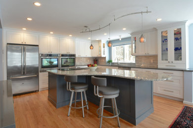 Large l-shaped light wood floor eat-in kitchen photo in Boston with a double-bowl sink, shaker cabinets, blue cabinets, granite countertops, multicolored backsplash, ceramic backsplash, stainless steel appliances and an island