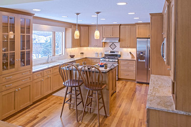Inspiration for a mid-sized timeless u-shaped medium tone wood floor and brown floor eat-in kitchen remodel in Minneapolis with an undermount sink, shaker cabinets, light wood cabinets, granite countertops, white backsplash, subway tile backsplash, stainless steel appliances and an island