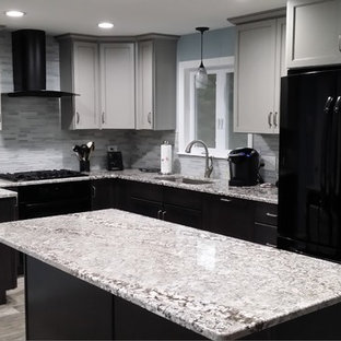 This is an example of a medium sized classic u-shaped open plan kitchen in Boston with a submerged sink, shaker cabinets, black cabinets, granite worktops, grey splashback, glass tiled splashback, stainless steel appliances, slate flooring, an island and grey floors.