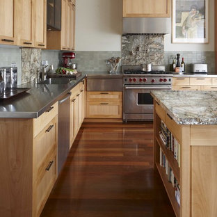 This is an example of a classic kitchen in San Francisco with stainless steel appliances, stainless steel worktops, shaker cabinets, light wood cabinets, green splashback and an integrated sink.