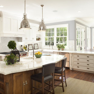 Eat-in kitchen - large traditional l-shaped dark wood floor eat-in kitchen idea in San Francisco with marble countertops, stainless steel appliances, white cabinets, white backsplash, a farmhouse sink, beaded inset cabinets, mosaic tile backsplash and an island